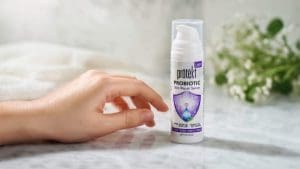 Prōtëkt® Probiotic Repair Serum bottle with serum drops on hand – patented probiotic face serum for skin microbiome repair, deep hydration, and relief